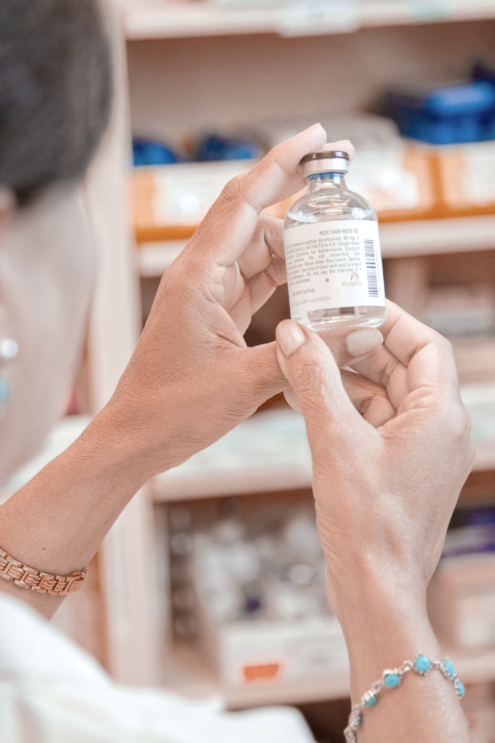 Pharmacist checking medication label